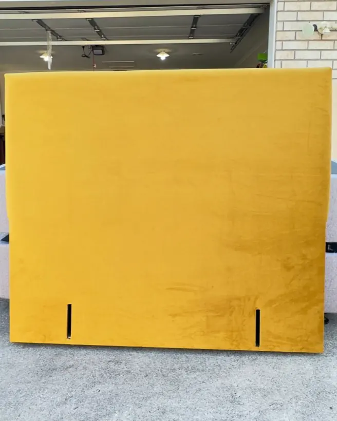 A mustard yellow headboard with a plain face, just finished.