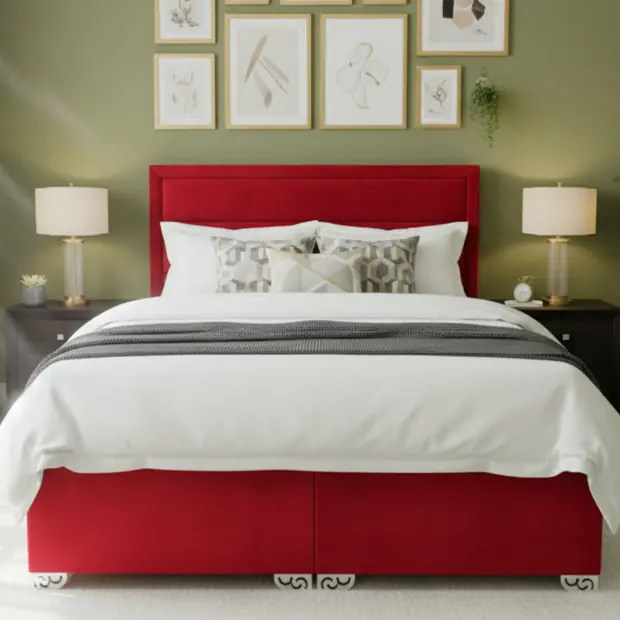 Red upholstered bed with carved legs in a styled bedroom scene.