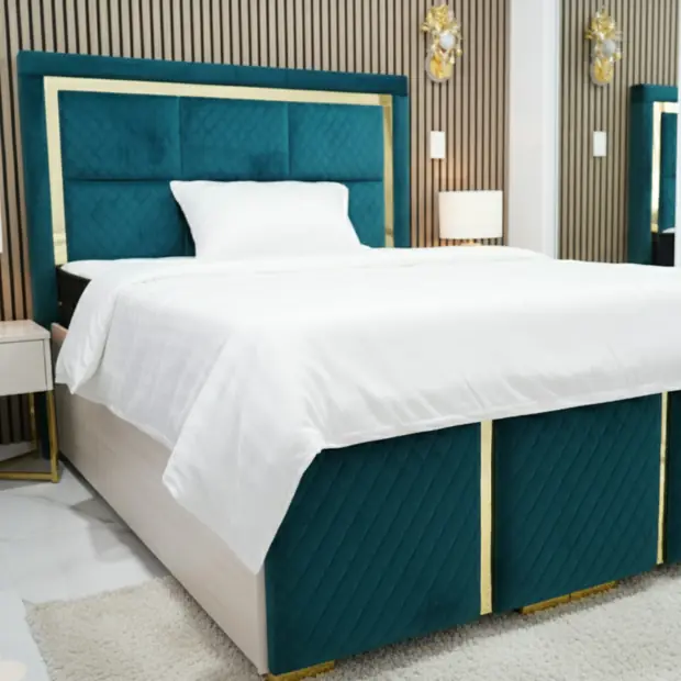 Teal quilted velvet bed with gold trim in a styled bedroom scene.