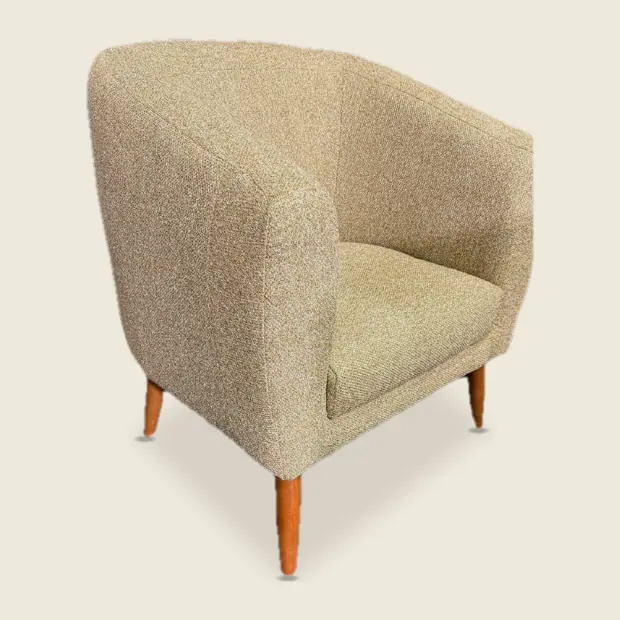 Mid-century modern tub chair in oatmeal tweed on tapered wooden legs, the whole chair from the front.
