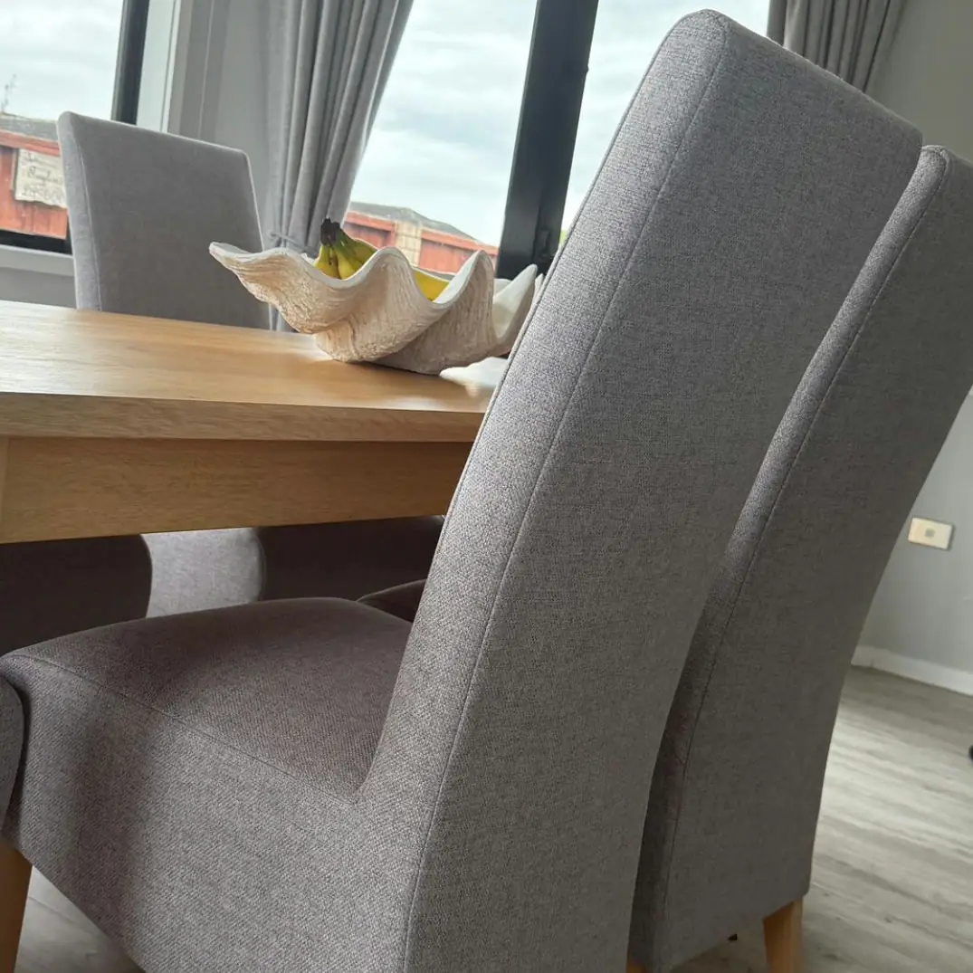 Grey high-backed dining chairs, reupholstered, front view